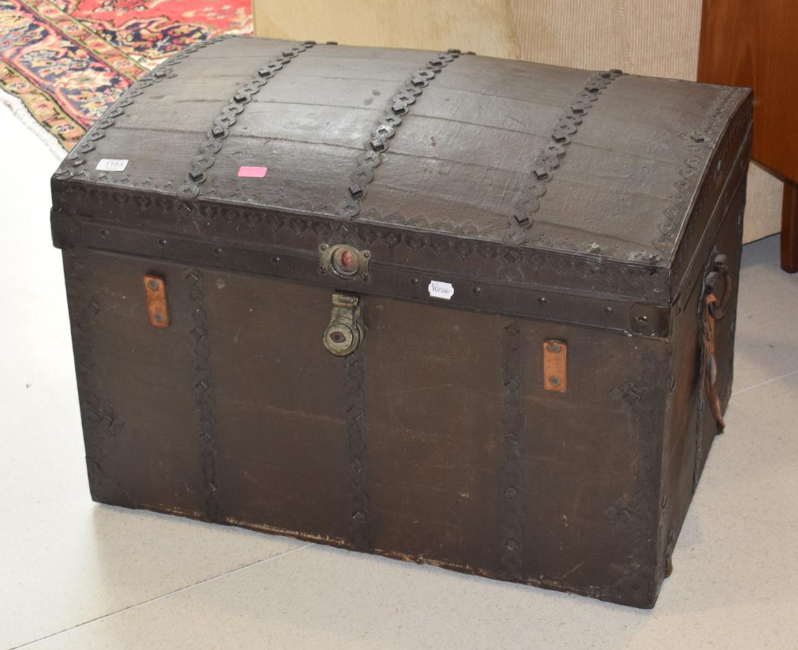 A dome topped metal mounted leather trunk