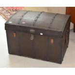 A dome topped metal mounted leather trunk