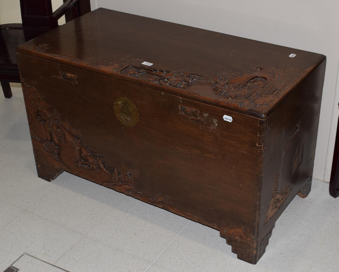 An early 20th century carved camphor wood chest, with hinged lid