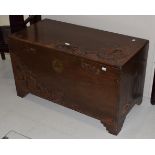 An early 20th century carved camphor wood chest, with hinged lid