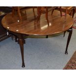 A George ll mahogany drop leaf dining table, the moulded edged oval top and arched frieze raised