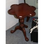 A reproduction carved tripod table