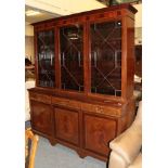 An inlaid and crossbanded mahogany astragal glazed triple bookcase; together with a large blue rug