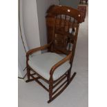 A mahogany rocking chair with turned spindle uprights