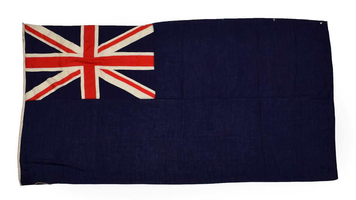 A British Blue Ensign, made-up of stitched linen panels, the cream hoist stencilled 4 YD ENSIGN,