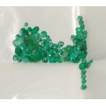 A quantity of loose emeralds, including an octagonal cut emerald weighing 2.03 carat