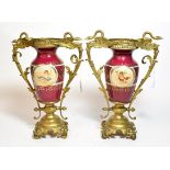 A pair of gilt metal twin handled porcelain vases, decorated with classical scenes, 34cm high