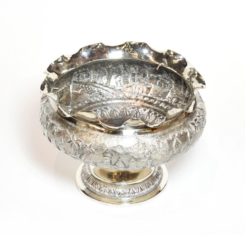 A late 19th century Indian or Burmese silver rose-bowl, stamped '90', the sides chased with building