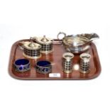 A four-piece Edward VII silver condiment-set, by Haseler and Bill, Chester, 1906, each piece with