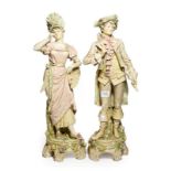 A pair of post 1919 Royal Dux figures of courtiers in 18th century dress, model numbers: 93 & 94,