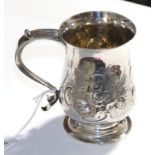 A George III silver mug, unidentified makers mark J.S, London 1771, baluster on spread foot with