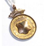 A 9 carat medallion with blank cartouche, length 3.8cm . Gross weight 5.67 grams.