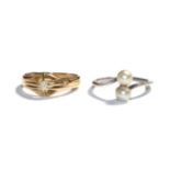 An 18 carat gold diamond solitaire ring, finger size M1/2; and a cultured pearl twist ring,