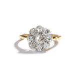 A diamond cluster ring, stamped '18CT&PT', estimated diamond weight 0.70 carat approximately, finger