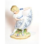 A 19th century Continental disc figure of a young girl dancing with tambourine, 40cm high