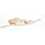 An early 20th century German bisque figure of a nude young woman, unmarked, modelled stretching with