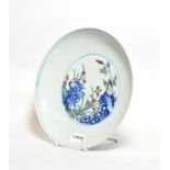 A Chinese blue and white saucer dish, decorated with flowers and bearing six character mark