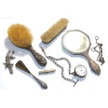 A silver pocket watch, four silver chains, a corkscrew and a dressing table set