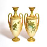 A pair of Royal Worcester blush ivory floral painted twin handled vases, shape number: 2129, 31cm