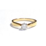An 18 carat gold diamond solitaire ring, the round brilliant cut diamond in a white claw setting