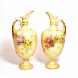 A pair of Royal Worcester blush ivory floral painted ewers, shape number: 1581, 34cm high