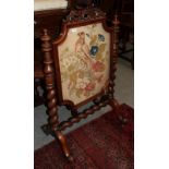 An early Victorian rosewood framed fire screen, mid 19th century, with original needlework fabric