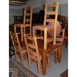 A reproduction oak dining table and six chairs