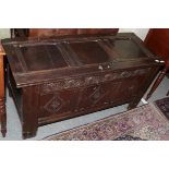 A late 17th century joined oak chest with hinged lid, pegged construction, carved foliate frieze and