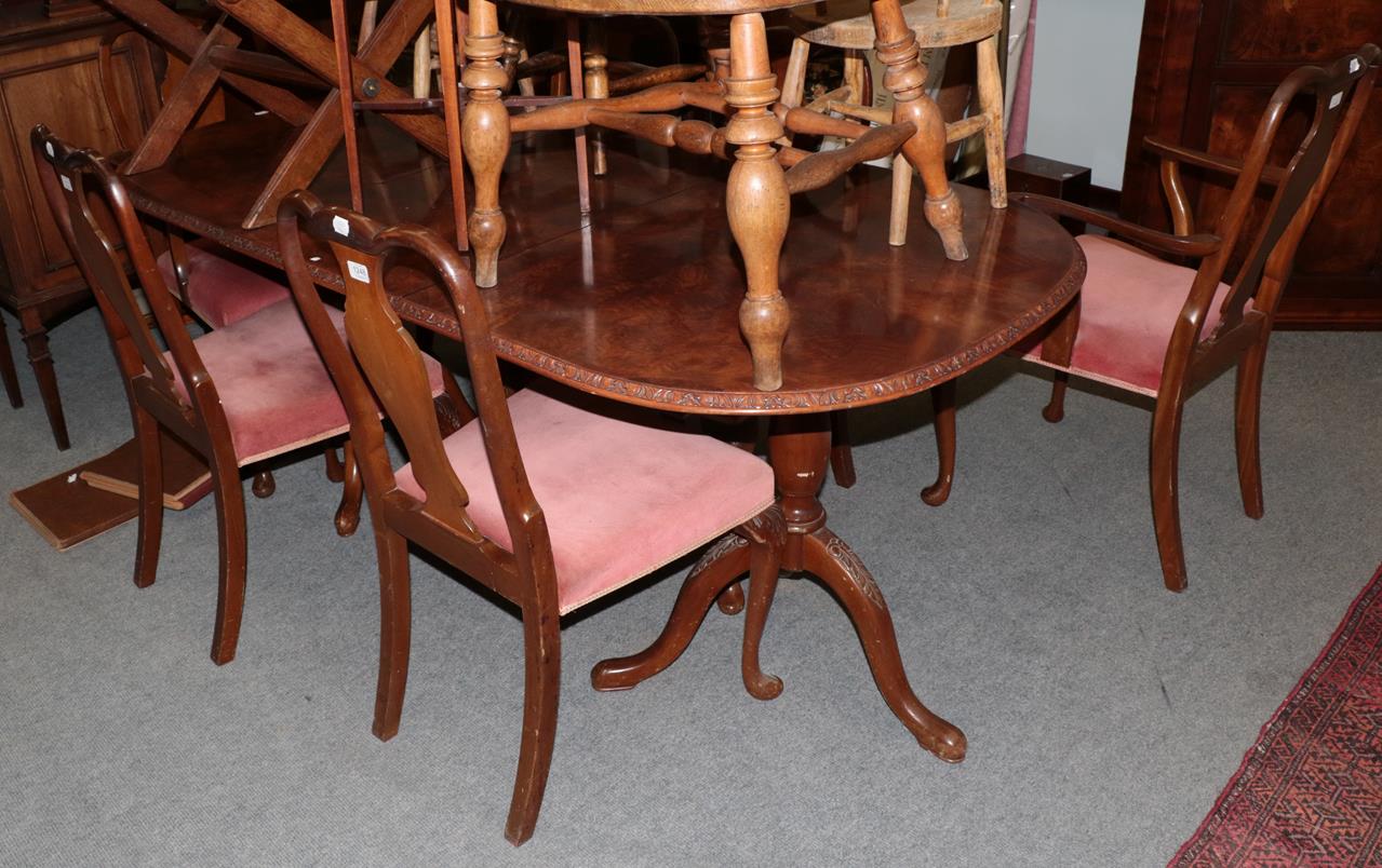 A walnut dining table together with a set of six chairs (7)