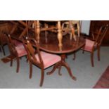 A walnut dining table together with a set of six chairs (7)