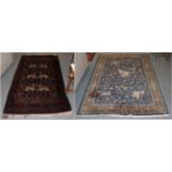 An Indian rug depicting a hunting scene, on an indigo field enclosed by cartouche borders 197cm by