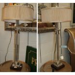 A pair of modern glass table lamps with gathered fabric shades