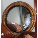 A Regency gilt and ebonised convex mirror