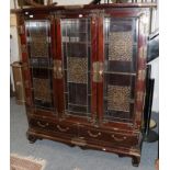 A Chinese glazed display cabinet applied with brass bat motifs