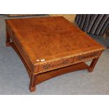 A reproduction walnut coffee table with four fitted drawers