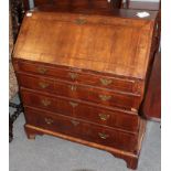 A mid-18th century walnut bureau with fitted interior and four drawers