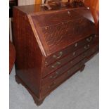 A George III oak bureau with fitted interior and four long drawers