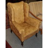 A late 19th century wing back chair upholstered in yellow fabric