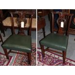 A pair of George III mahogany dining chairs with cream close-nailed leather seats