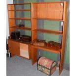 A 1970's teak free standing bookcase with sliding glass doors and cupboard base