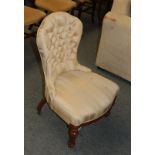 A Victorian walnut nursing chair in button fabric