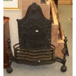 A large black painted serpentine shaped fire grate and fire back