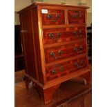 A reproduction yew wood five drawer chest of drawers and a reproduction yew wood hall table