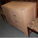 A modern limed oak cabinet fitted with three short drawers next to a cupboard door, 90cm high by