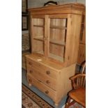 A Victorian pine three drawer chest with associated bookcase top