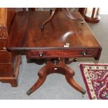 A Regency mahogany sofa table raised on sabre legs