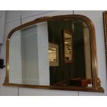 A large reproduction gilt over mantel mirror, arched frame