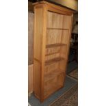 A reproduction oak free standing bookcase