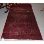 A Mashad Baluch rug, the honeycomb lattice field enclosed by borders of stepped guls, 225cm by