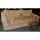 A modern three-seater sofa in pale corduroy fabric